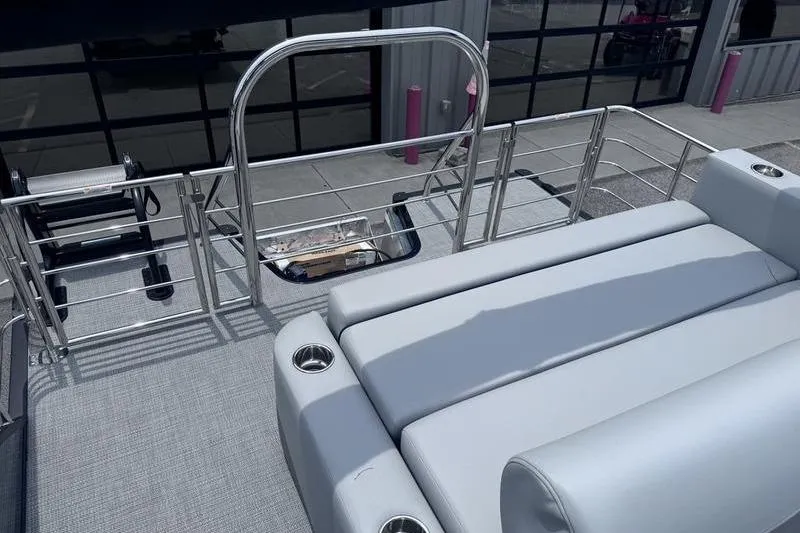 Slide: The Image of 2027 Manitou Aurora 23 SL SHP boat with sleek seating and stainless steel railings. - 31