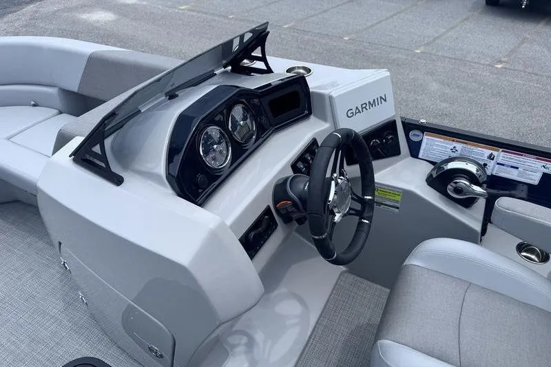 Slide: The Image of 2027 Manitou Aurora 23 SL SHP boat dashboard with Garmin navigation system. - 12