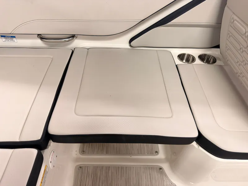 Slide: The Image of The image shows a white seat with black accents and cup holders. - 15