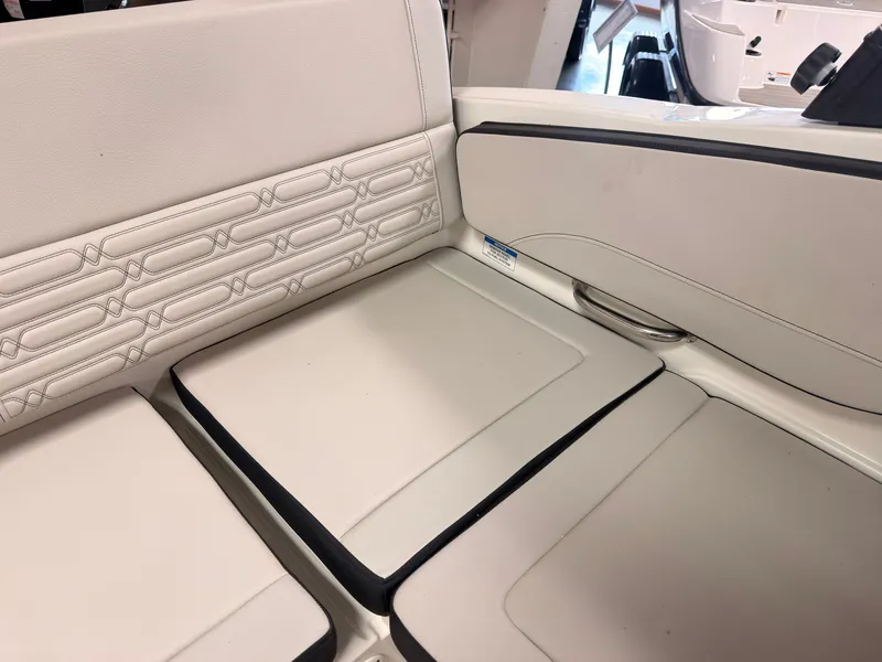 Slide: The Image of The 2026 Sea Ray SPX 210 interior features elegant, cream-colored upholstery. - 13