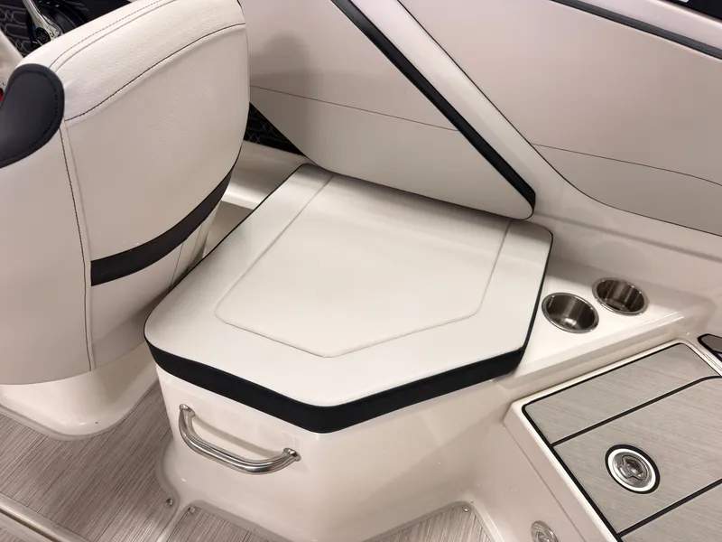 Slide: The Image of A sleek seating area with white upholstery and black accents. Two cup holders are integrated. - 18