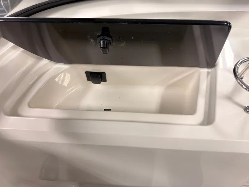 Slide: The Image of An open storage compartment on a 2026 Sea Ray SPX 210 boat. - 25