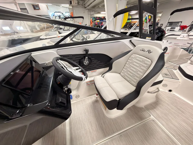 Slide: The Image of The image shows the cockpit of a 2026 Sea Ray SPX 210 with a sleek steering wheel and comfortable seating. - 26