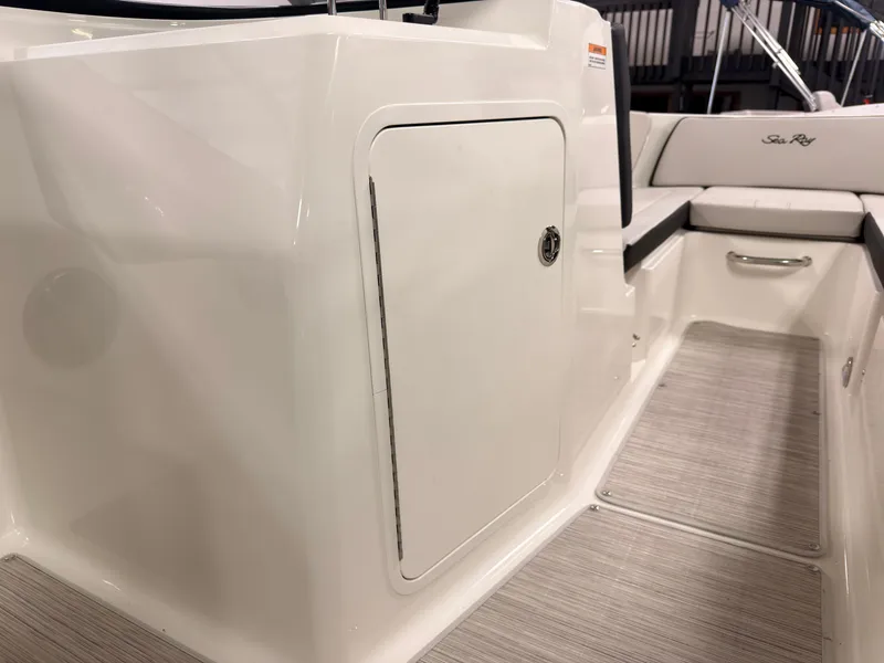 Slide: The Image of The image shows the cockpit of a 2026 Sea Ray SPX 210 with white upholstery. - 38