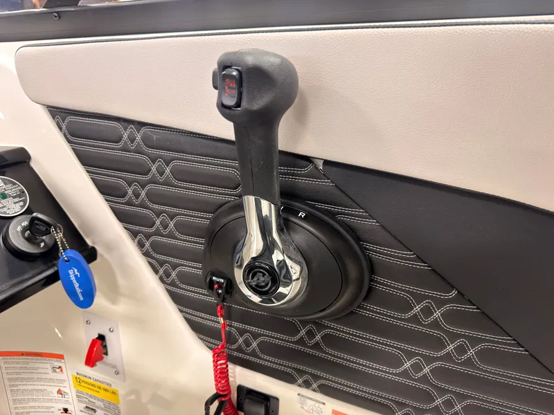 Slide: The Image of Close-up of a throttle lever in a 2026 Sea Ray SPX 210 boat. - 33