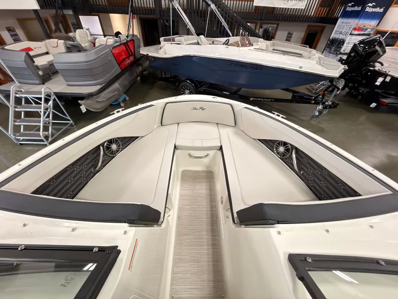Slide: The Image of The image shows the bow seating area of a 2026 Sea Ray SPX 210 boat in a showroom. - 40