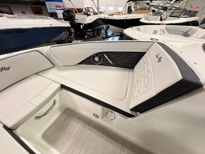 Slide: The Image of The image shows the interior of a 2026 Sea Ray SPX 210 boat with white upholstery. - 43