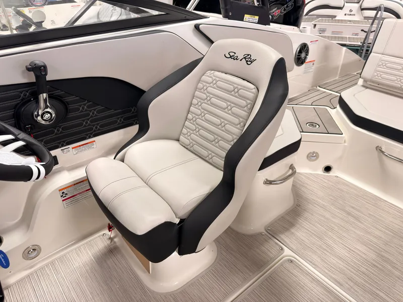 Slide: The Image of The 2026 Sea Ray SPX 210 features a sleek, upholstered captain's chair with a modern design. - 27