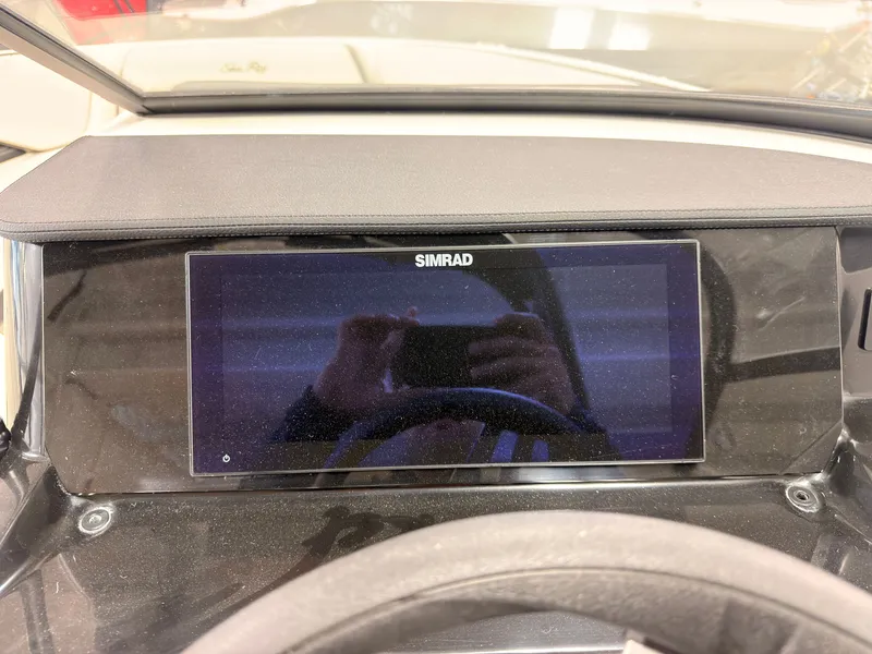 Slide: The Image of The image shows a Simrad display on the dashboard of a Sea Ray SPX 210 boat. - 30