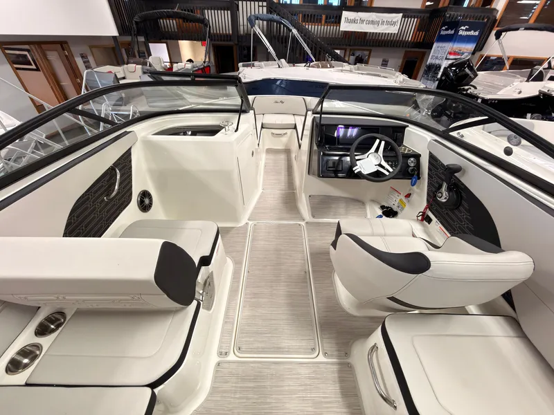 Slide: The Image of The image shows the cockpit of a Sea Ray SPX 210 boat with white seating and a modern helm. - 20