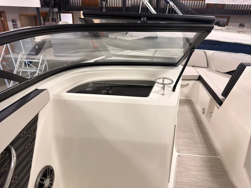 Slide: The Image of The image shows the cockpit of a 2026 Sea Ray SPX 210 boat with modern seating and a cup holder. - 23
