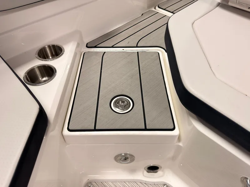 Slide: The Image of Close-up of a Sea Ray SPX 210 boat featuring sleek wood paneling and stainless steel cup holders. - 16