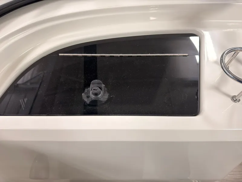 Slide: The Image of Close-up of a boat window with a small ventilation valve. - 24