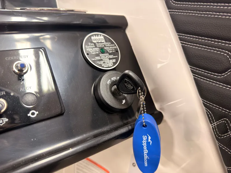 Slide: The Image of Close-up of a Sea Ray SPX 210 boat ignition switch with a blue keychain. - 32