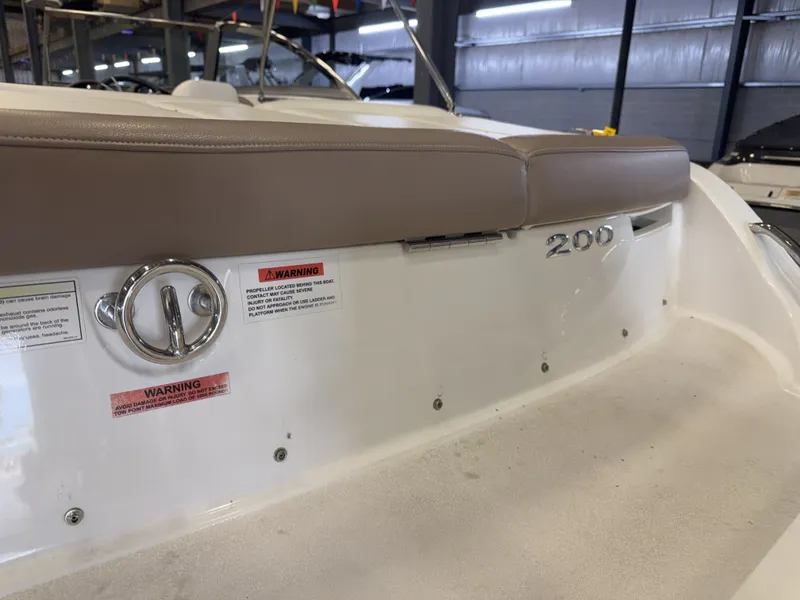 Slide: The Image of The image shows the stern of a 2015 Cobalt 200 boat with brown upholstery. - 12