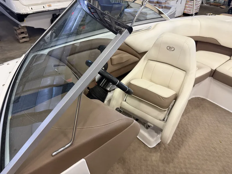Slide: The Image of Interior view of a 2015 Cobalt 200 boat with beige upholstery and steering wheel. - 25