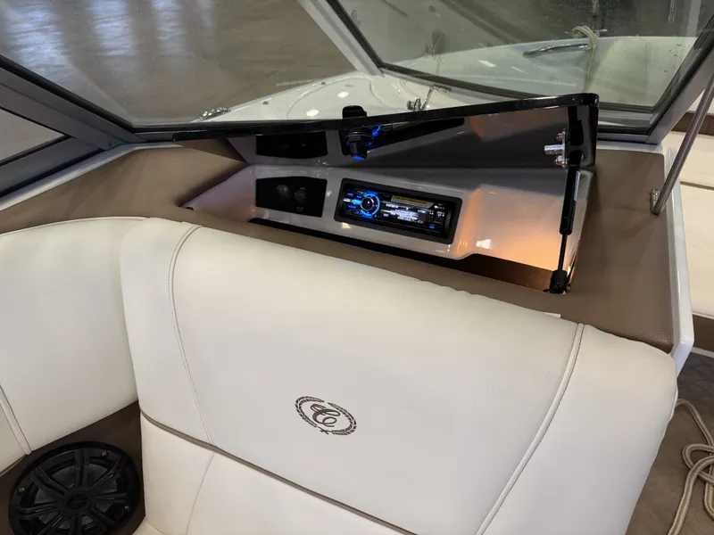 Slide: The Image of Interior of a 2015 Cobalt 200 boat with beige upholstery and a modern audio system. - 23