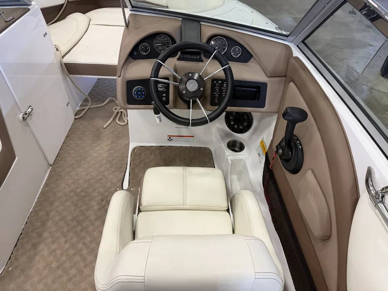 Slide: The Image of Interior view of a 2015 Cobalt 200 boat with beige and white interior. - 27