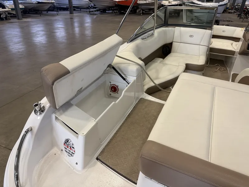 Slide: The Image of Interior view of a 2015 Cobalt 200 boat with beige and white seating. - 14