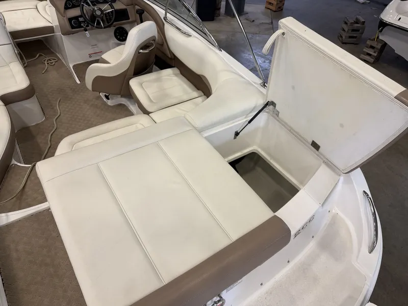 Slide: The Image of Interior of a 2015 Cobalt 200 boat with white and brown seating and storage compartment. - 16