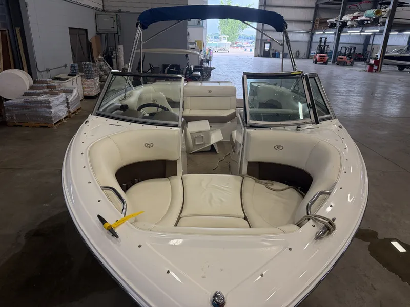 Slide: The Image of A 2015 Cobalt 200 boat with white interior in a warehouse setting. - 8