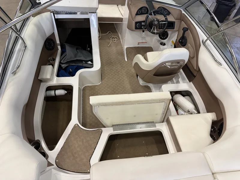 Slide: The Image of Interior of a 2015 Cobalt 200 boat with beige and white seating. - 18