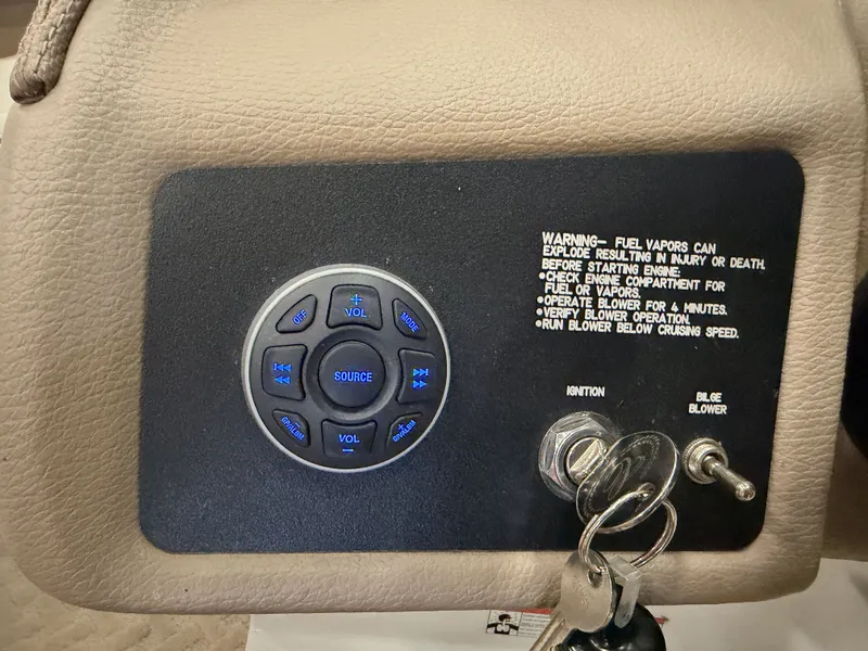 Slide: The Image of Close-up of a boat ignition switch with key and control buttons. - 33