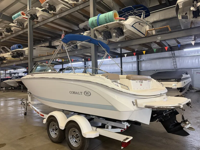 Slide: The Image of A 2015 Cobalt 200 boat on a trailer in a warehouse setting. - 2