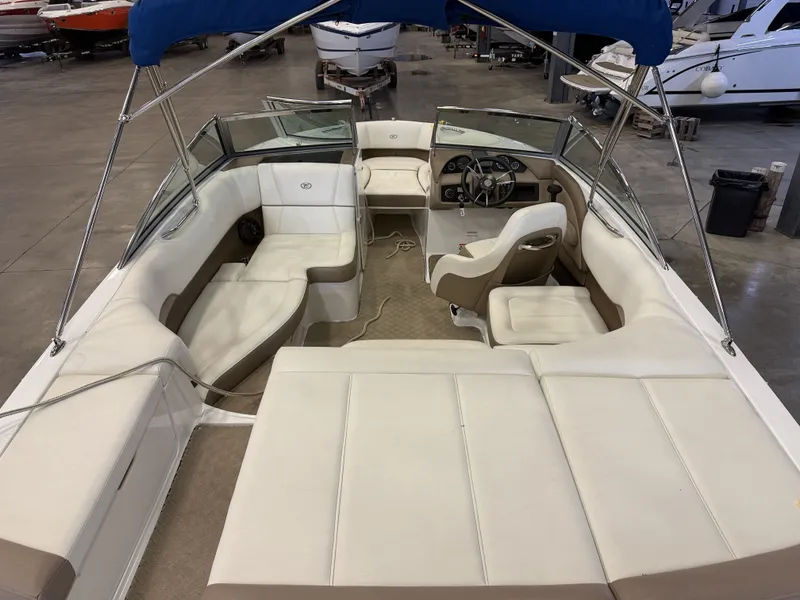 Slide: The Image of The image shows the interior of a 2015 Cobalt 200 boat with beige and white seating. - 13