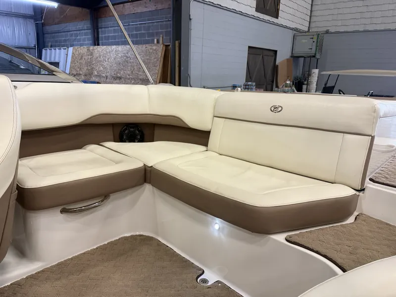 Slide: The Image of Interior view of a 2015 Cobalt 200 boat with beige and white upholstery. - 19