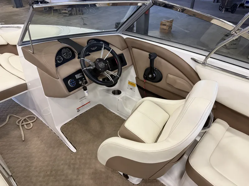 Slide: The Image of The image shows the cockpit of a 2015 Cobalt 200 boat with beige and white interior. - 24