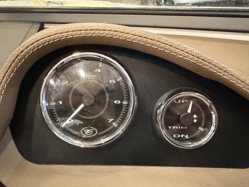 Slide: The Image of Close-up of two boat gauges, a tachometer and a trim indicator, in a Cobalt 200. - 31