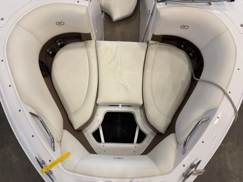 Slide: The Image of Interior view of a 2015 Cobalt 200 boat with white cushioned seating. - 39