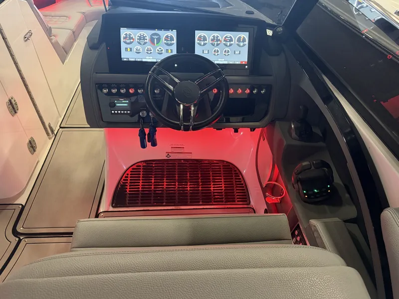 Slide: The Image of The image shows the cockpit of a 2022 Cobalt R30 boat with modern instruments and red lighting. - 33