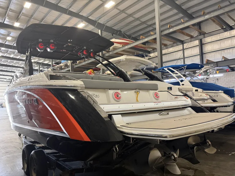 Slide: The Image of A 2022 Cobalt R30 boat in a warehouse. It features a sleek design with red accents. - 7