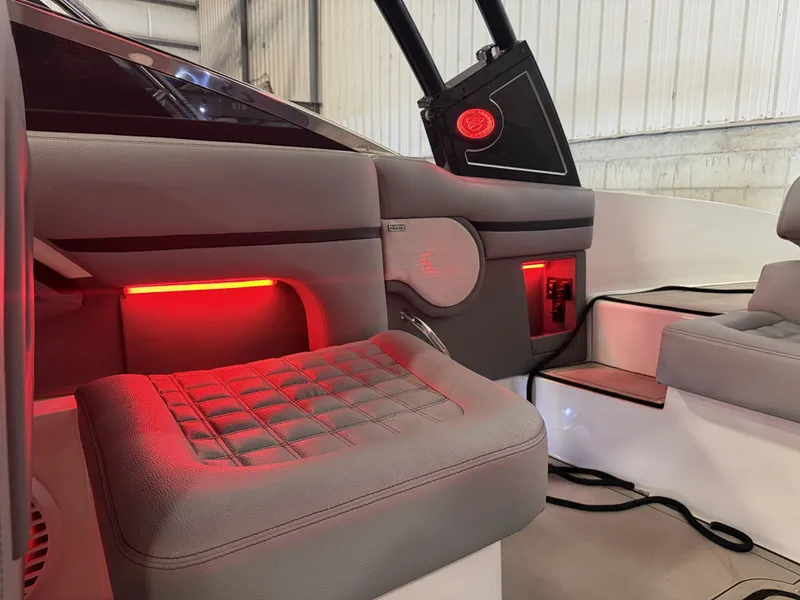 Slide: The Image of The image shows the interior of a 2022 Cobalt R30 boat with red LED lighting. - 28