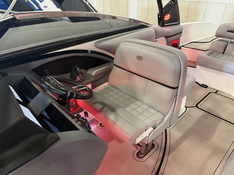 Slide: The Image of The image shows the cockpit of a 2022 Cobalt R30 boat with gray leather seats. - 31