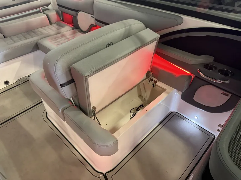 Slide: The Image of The image shows the interior of a 2022 Cobalt R30 boat with gray upholstery and storage space. - 26
