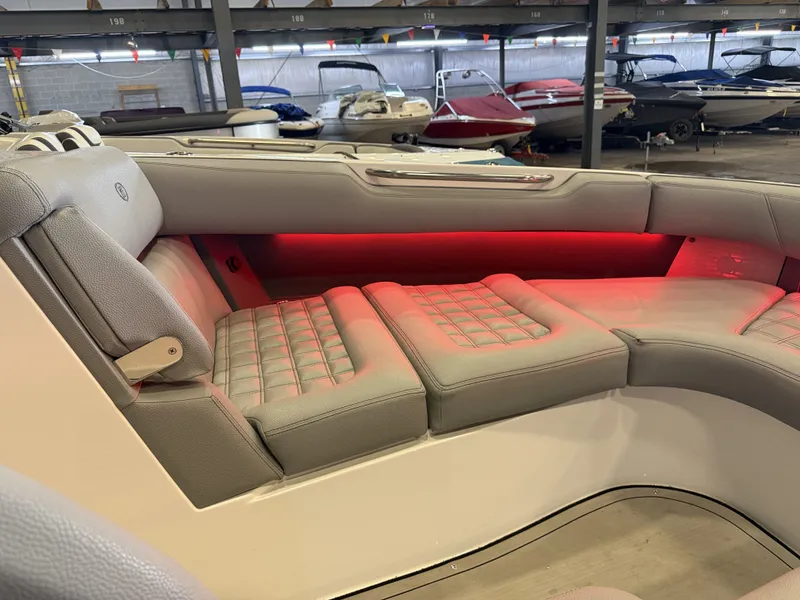 Slide: The Image of The image shows the luxurious cockpit of a Cobalt R30 boat with cushioned seats and red lighting. - 48