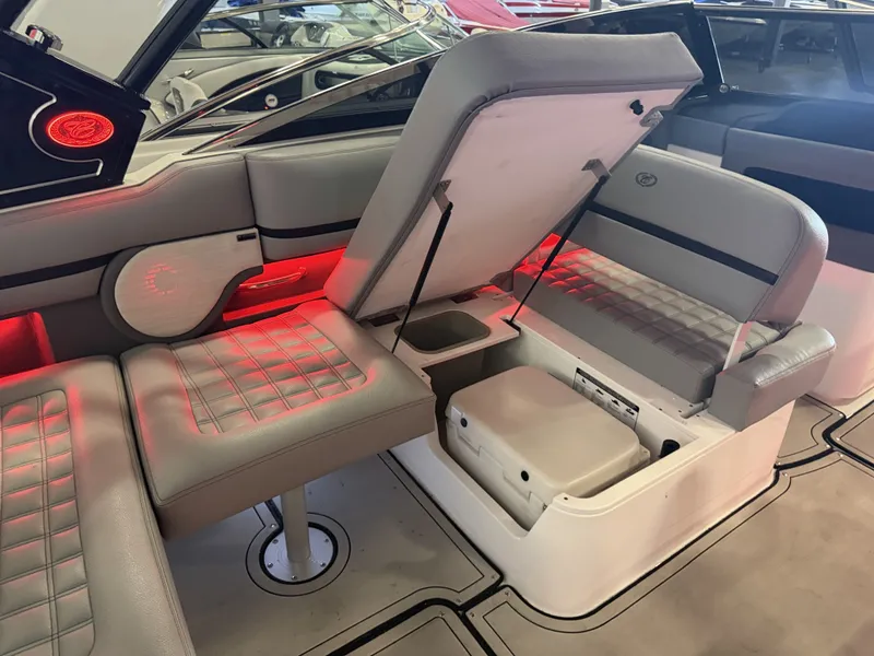 Slide: The Image of The image shows the interior of a 2022 Cobalt R30 boat with gray upholstery and red lighting. - 24