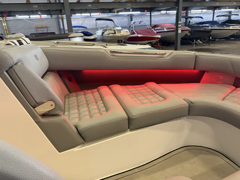 Slide: The Image of The image shows the luxurious interior of a Cobalt R30 boat with cushioned seating and red lighting. - 50