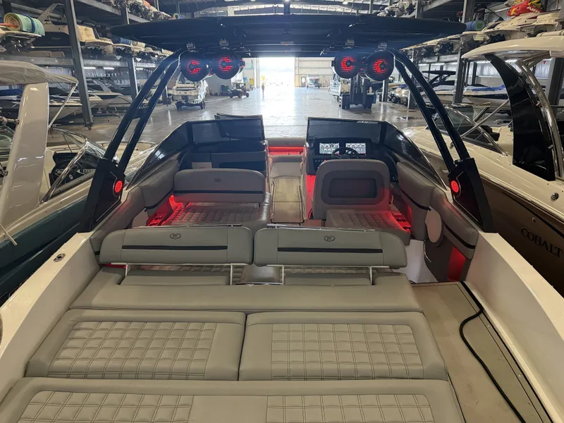 Slide: The Image of The image shows the interior of a 2022 Cobalt R30 boat with gray seating and red lights. - 16
