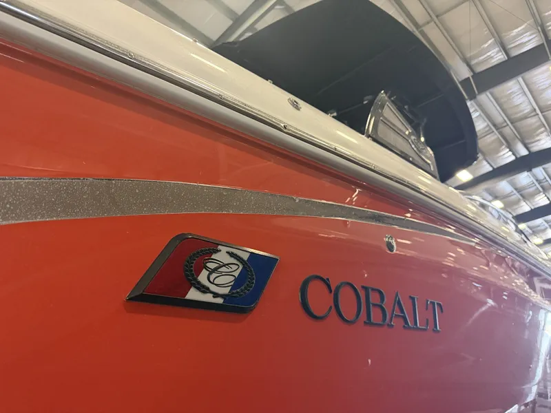 Slide: The Image of An orange 2022 Cobalt R30 boat in a warehouse, featuring a prominent logo. - 6