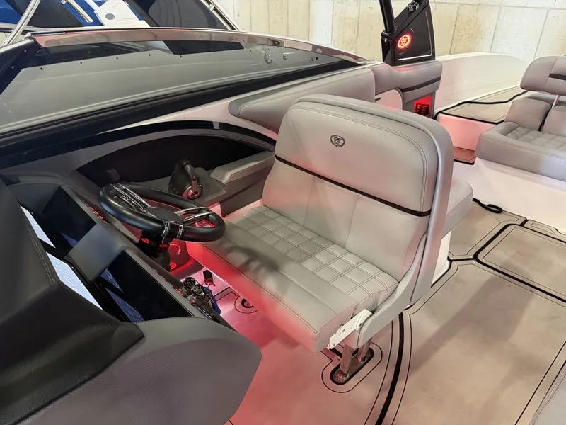 Slide: The Image of The image shows the helm of a Cobalt R30 boat with gray seats and red lighting. - 29
