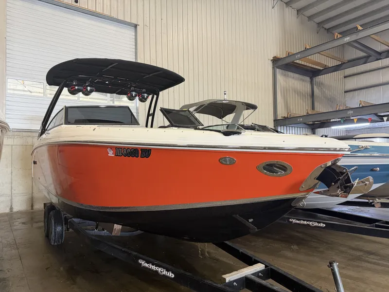 The Image of An orange 2022 Cobalt R30 boat is on a trailer in a warehouse. - 1