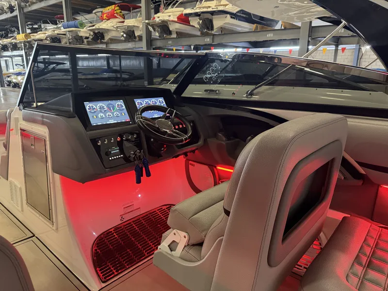 Slide: The Image of The image shows the cockpit of a 2022 Cobalt R30 boat with modern instruments and red lighting. - 32