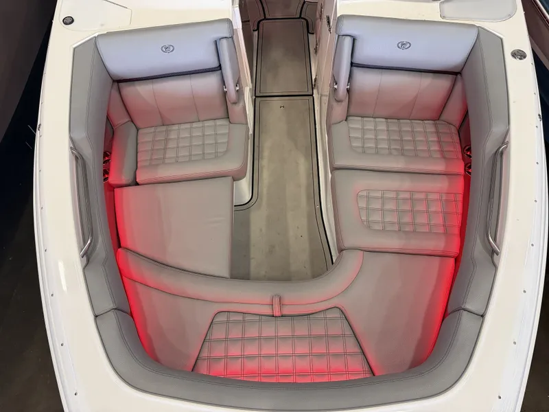 Slide: The Image of The image shows the cockpit of a 2022 Cobalt R30 boat with gray upholstery and red lighting. - 45