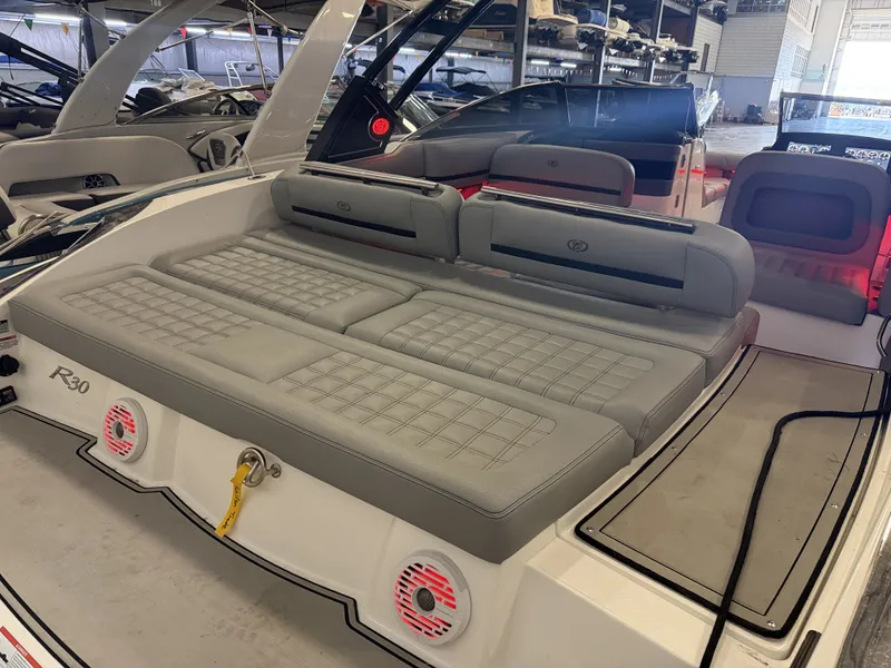 Slide: The Image of The image shows the stern of a 2022 Cobalt R30 boat with gray upholstery. - 13