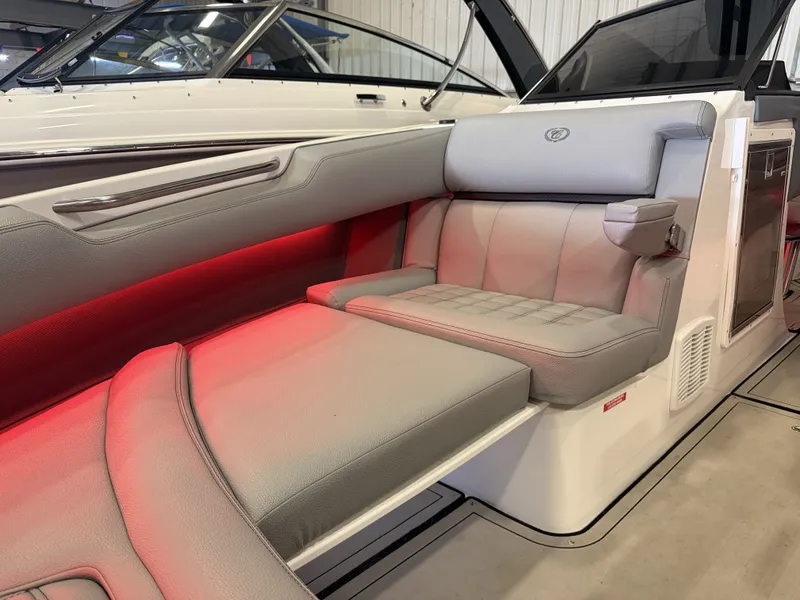 Slide: The Image of The image shows the interior of a 2022 Cobalt R30 boat with gray upholstery and red lighting. - 49