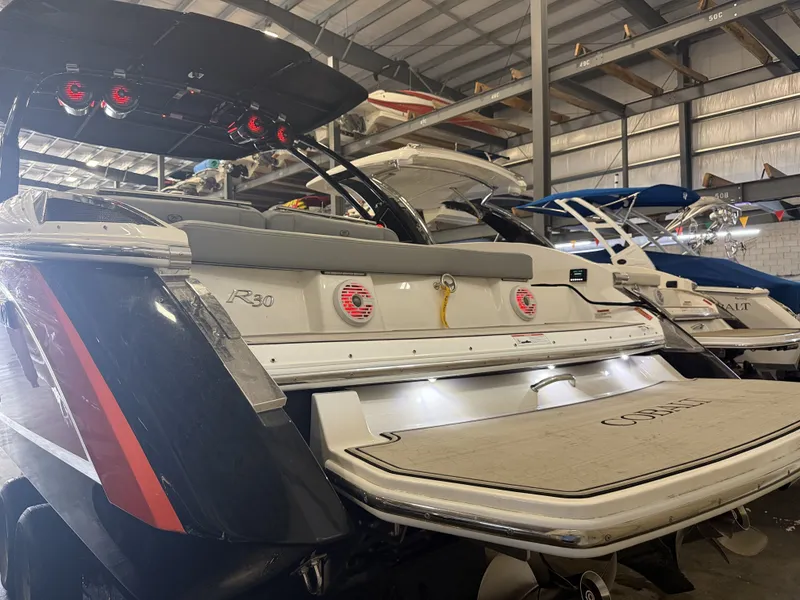 Slide: The Image of A 2022 Cobalt R30 boat is in a warehouse. It features sleek design and modern amenities. - 8